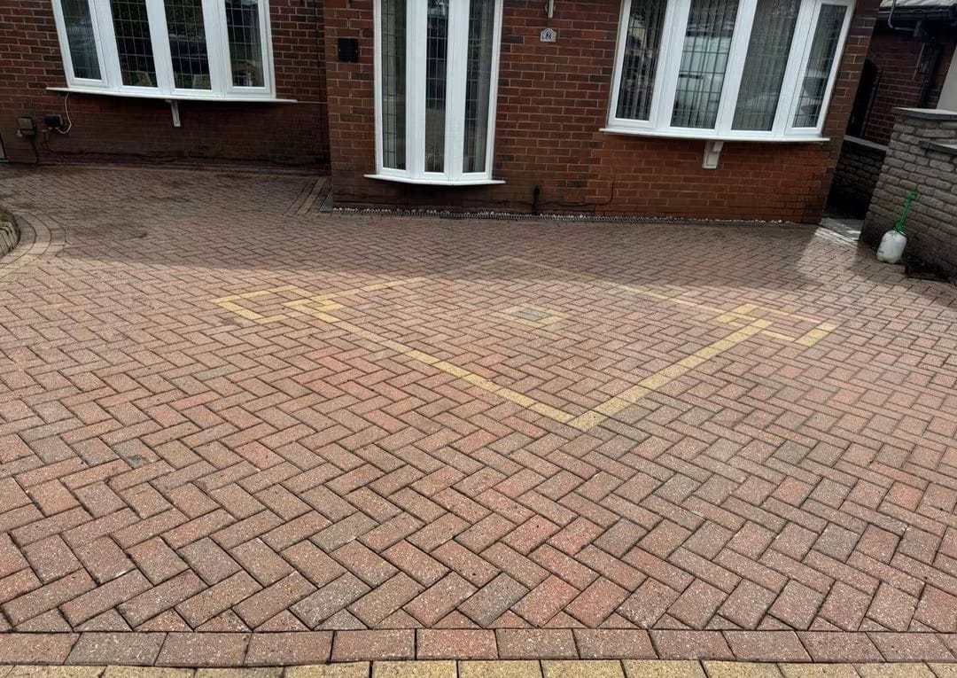 Red block paving driveway at the front of a bungalow after cleaning, brighter red